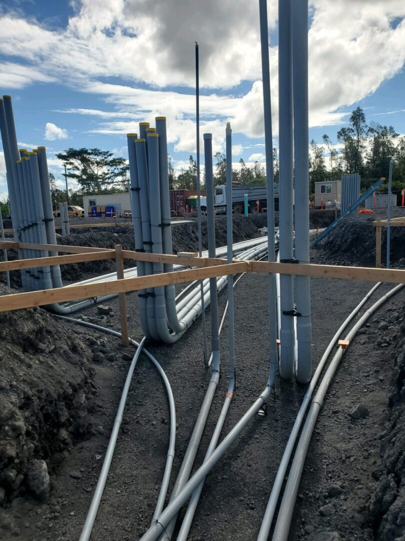 A construction site with many pipes and poles.